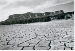 Cracked dry land during Texas 1950s drought. Photo credit.