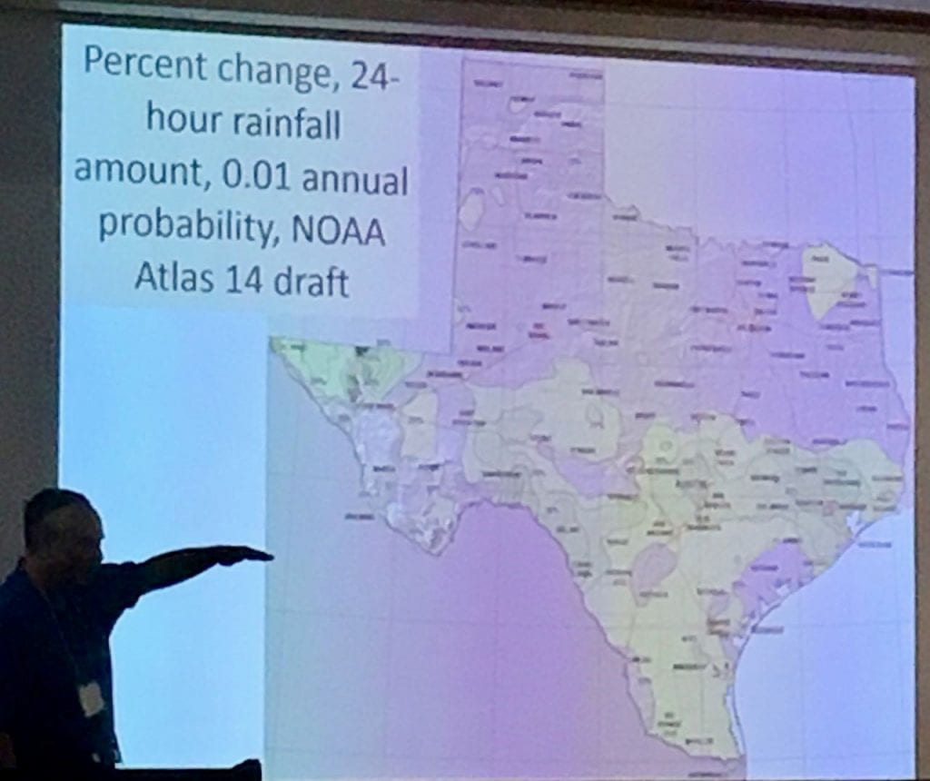 Figure 1b: John Nielsen-Gammon discusses changes in Atlas 14 in the 1 percent probability map for Texas. Areas in tan will see higher rainfall amounts for the 1-percent-chance 24-hour rainfall amount. [photo by the author].